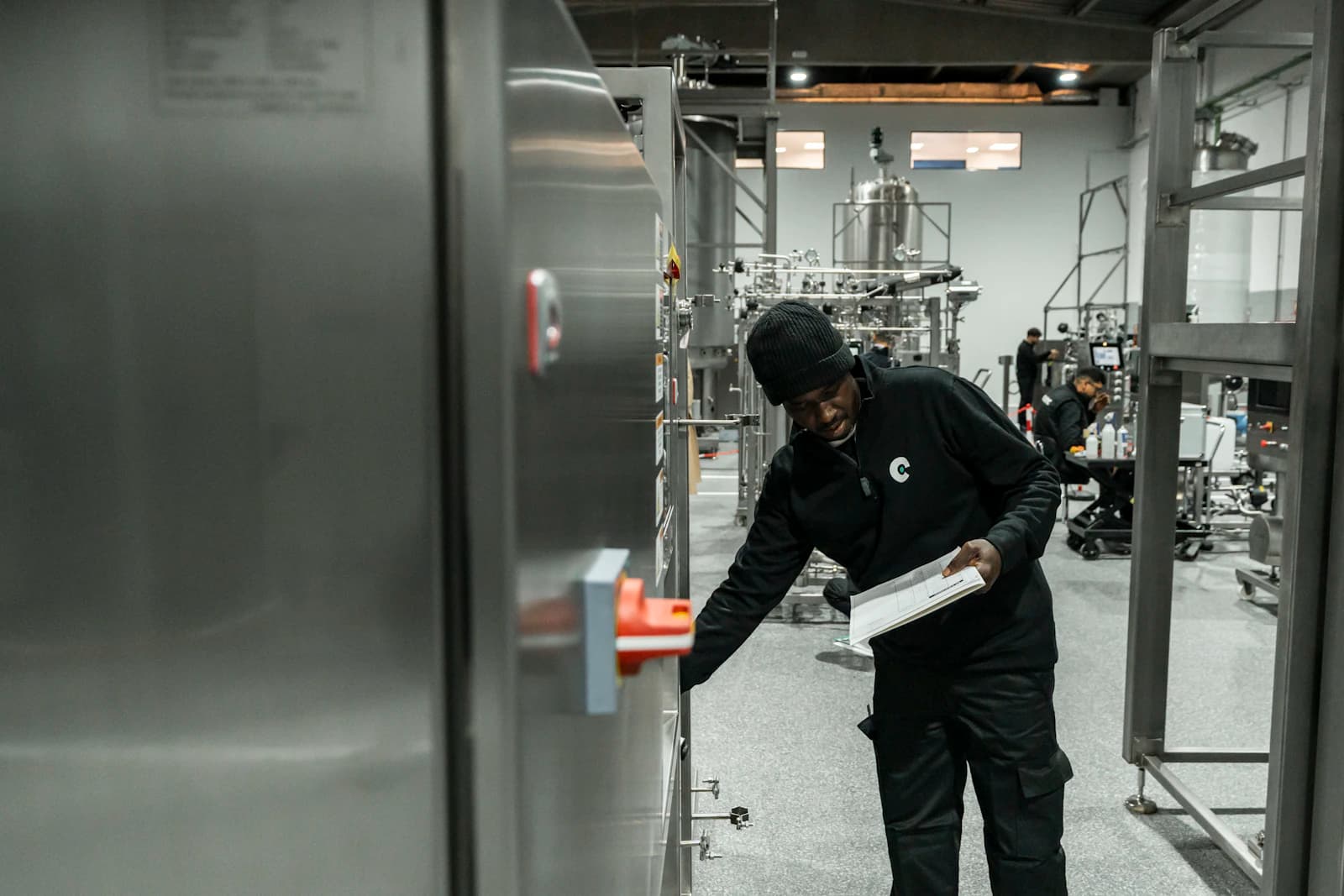 A technician inspecting equipment in a modern manufacturing facility